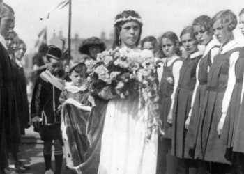 Annie Harper, Queen of the Sea 1933. Miss Annie Harper, en route to her crowning passing pupils from Kyleshill School. The pageant was inaugurated by the Town Council as part of the celebrations to mark the Quater Centenary (1528-1928) of the forming of Saltcoats into a Burgh of Barony.