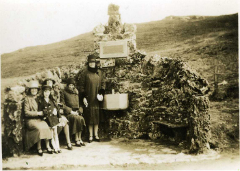 A family having a rest and a refreshing drink at the Millport Mineral Well.